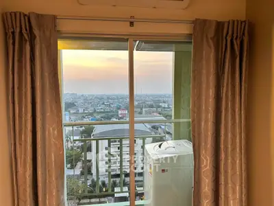 Stunning high-rise apartment view with balcony overlooking cityscape at sunset.