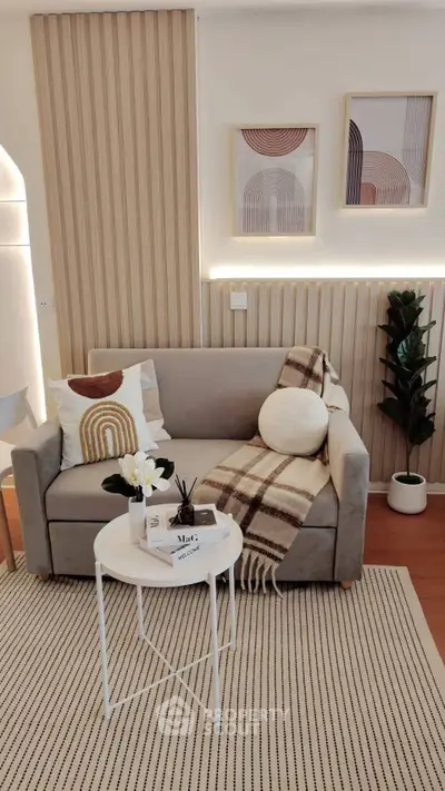 Stylish living room with modern decor, cozy sofa, and elegant wall art, perfect for relaxation and entertaining.
