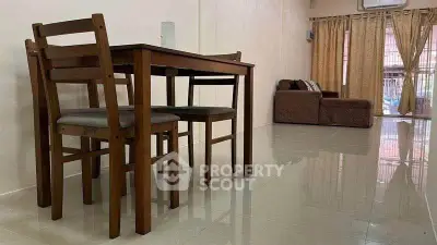 Spacious living room with dining area and cozy sofa, perfect for family gatherings.