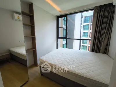 Modern bedroom with large window and minimalist design in urban apartment