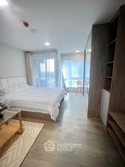 Spacious modern bedroom with large windows and stylish decor