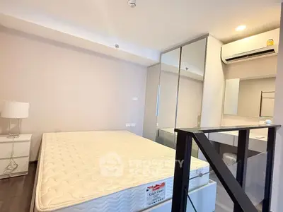 Modern bedroom with stylish decor and built-in wardrobe, featuring a comfortable mattress and sleek air conditioning unit.