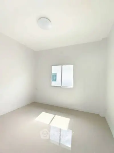 Bright empty room with glossy tiled floor and window, perfect for customization.