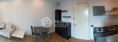 Modern studio apartment with compact kitchen and cozy living area, perfect for urban living.