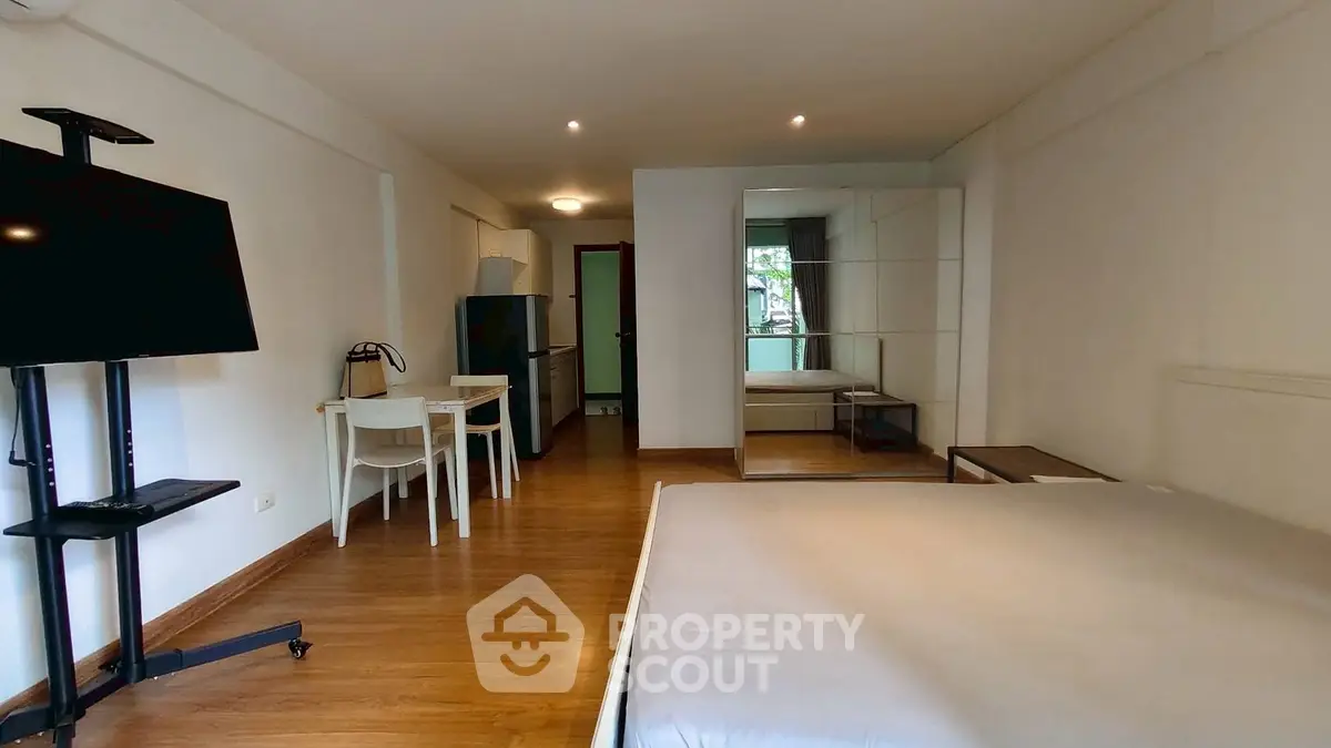 Spacious studio apartment with modern furnishings and hardwood floors