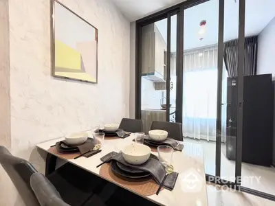 Modern dining area with elegant table setting and kitchen view