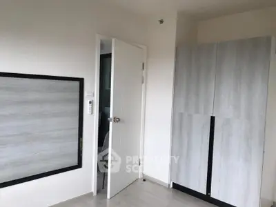 Modern minimalist interior with sleek wardrobe and open door