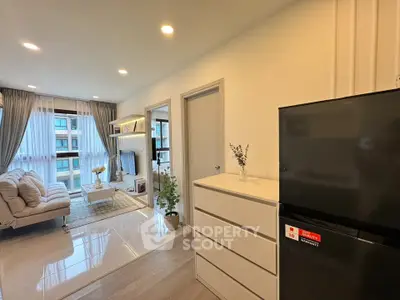 Modern living room with stylish decor and natural light, featuring a cozy sofa and sleek storage solutions.