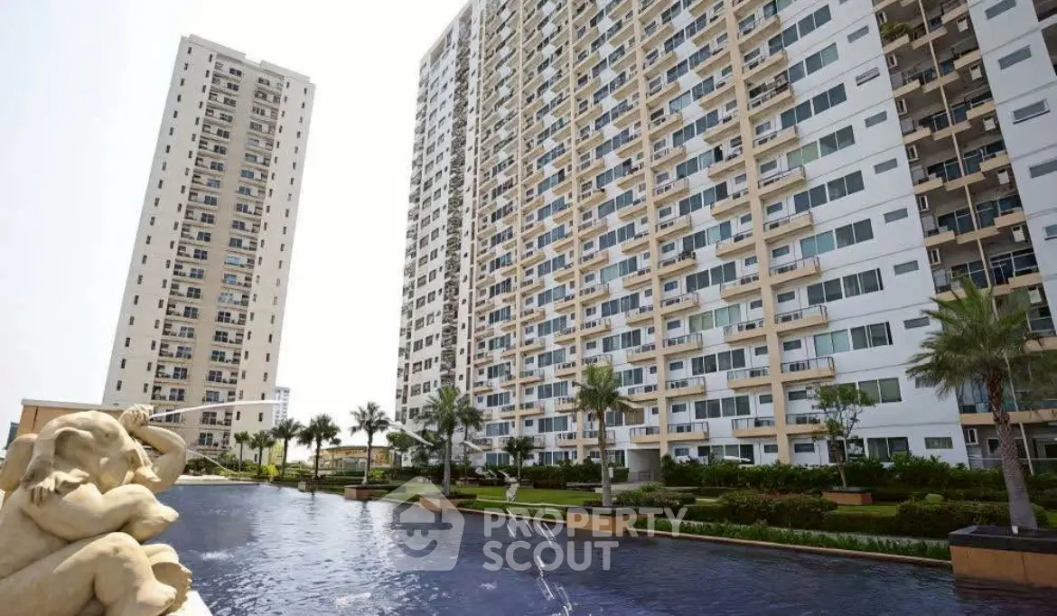 Luxurious high-rise apartment complex with serene pool and lush landscaping