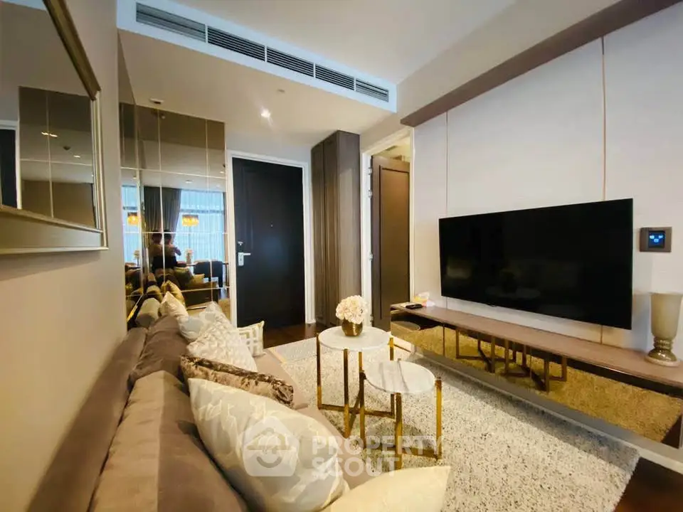 Modern living room with sleek design, featuring a large TV, comfortable sofa, and stylish decor.