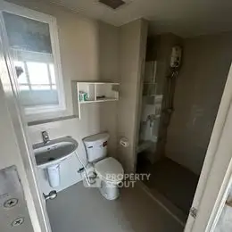 Compact modern bathroom with shower and sleek fixtures