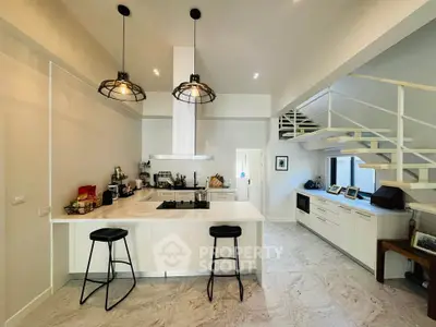 Modern kitchen with open layout and stylish lighting in a contemporary home