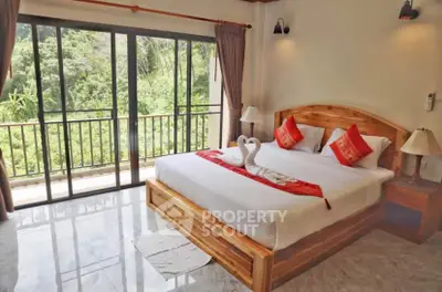 Spacious bedroom with scenic balcony view and elegant wooden furniture