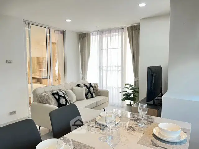 Modern living room with elegant dining area and natural light