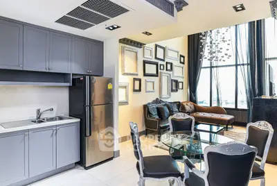 Luxurious modern living room with elegant decor and open kitchen layout, featuring stylish furniture and large windows.