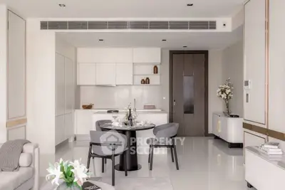 Modern open-plan living room with sleek kitchen and elegant dining area in luxury apartment.