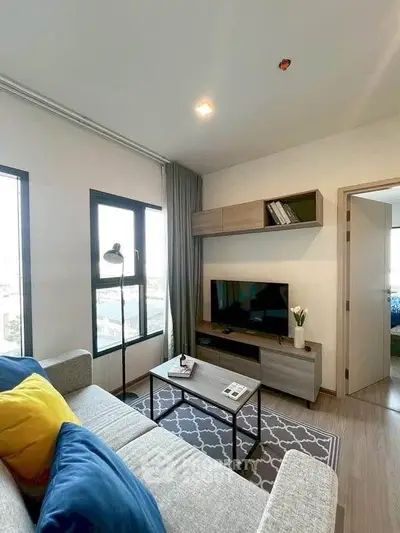 Modern living room with stylish decor and natural light in a cozy apartment.