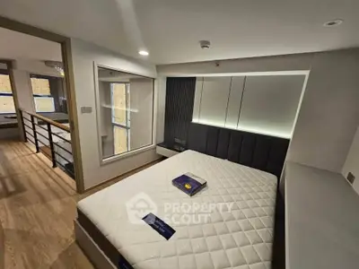 Modern bedroom with stylish decor and large windows in a contemporary apartment.