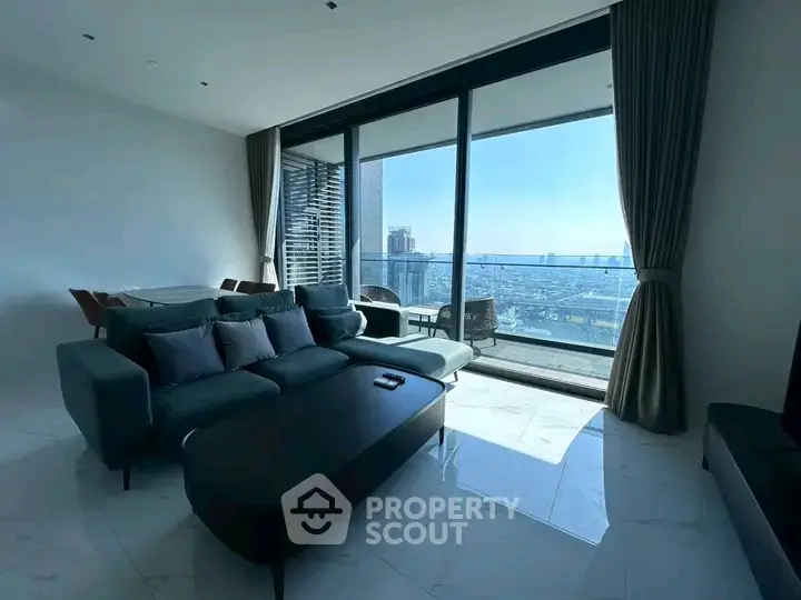 Luxurious living room with stunning city view and spacious balcony access.