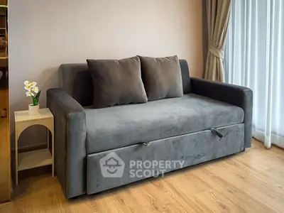 Modern living room with stylish gray sofa and elegant decor