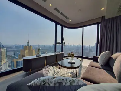 Luxurious living room with panoramic city view and modern furnishings.