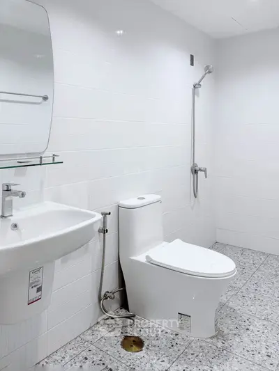 Modern minimalist bathroom with white tiles and sleek fixtures