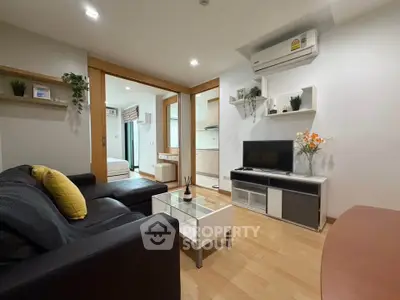 Modern living room with sleek furniture and open layout in a stylish apartment.