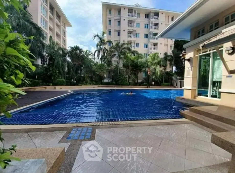 Luxurious residential complex with inviting swimming pool and lush greenery.