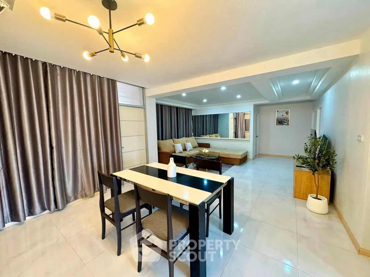 Spacious modern living room with elegant dining area and stylish lighting