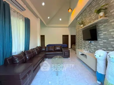 Spacious living room with modern decor and plush leather seating