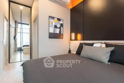 Modern bedroom with stylish decor and mirrored closet doors