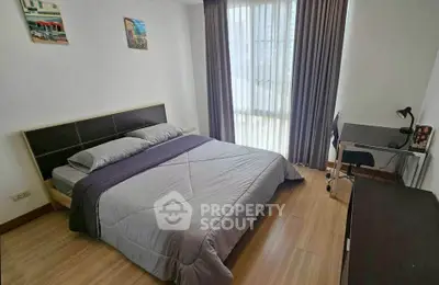 Modern bedroom with cozy bed, study desk, and large window with curtains.