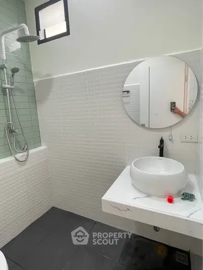 Modern bathroom with round mirror and stylish shower