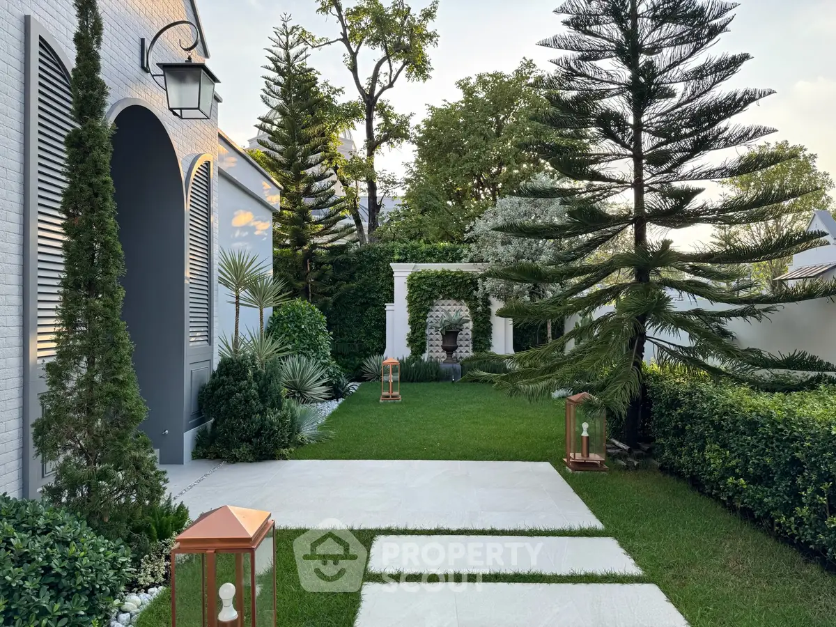 Luxurious garden with manicured lawn and elegant landscaping, perfect for outdoor relaxation.