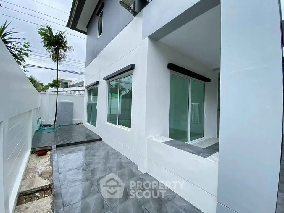 Modern exterior of a stylish home with sleek design and large windows, perfect for contemporary living.