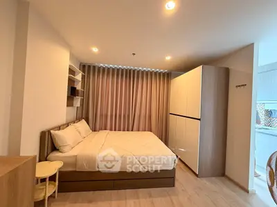 Modern bedroom with cozy bed and ample storage in stylish apartment