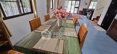 Spacious living room with elegant dining area and stylish decor