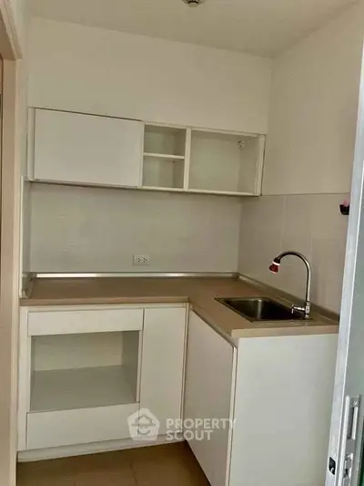 Compact modern kitchen with sleek cabinetry and stainless steel sink
