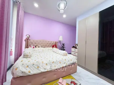 Charming bedroom with plush bed, modern wardrobe, and soft lighting, perfect for cozy living.