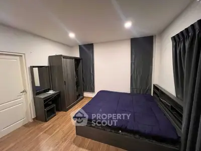 Modern bedroom with sleek furniture and cozy ambiance, featuring a stylish bed and wardrobe.