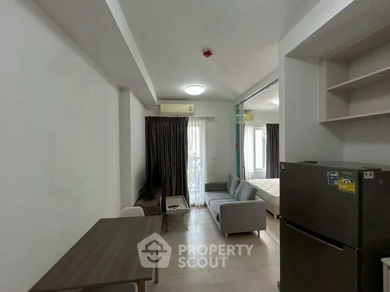 Modern apartment interior with cozy living area and compact kitchen