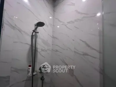Modern bathroom shower with elegant marble tiles and sleek fixtures