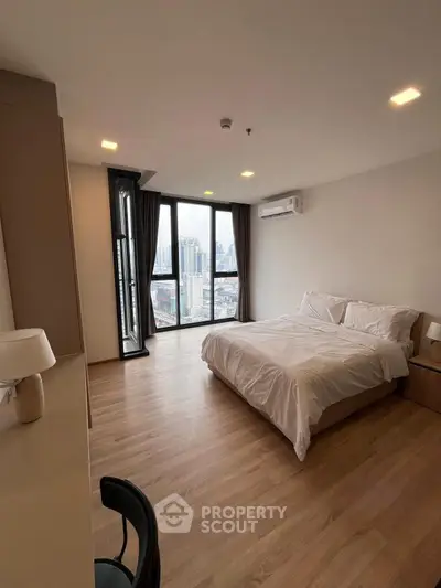 Spacious modern bedroom with city view and elegant furnishings