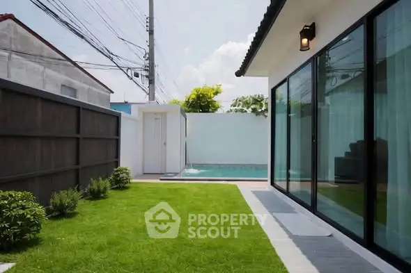 Modern home exterior with lush green lawn and private pool, perfect for relaxation and entertainment.