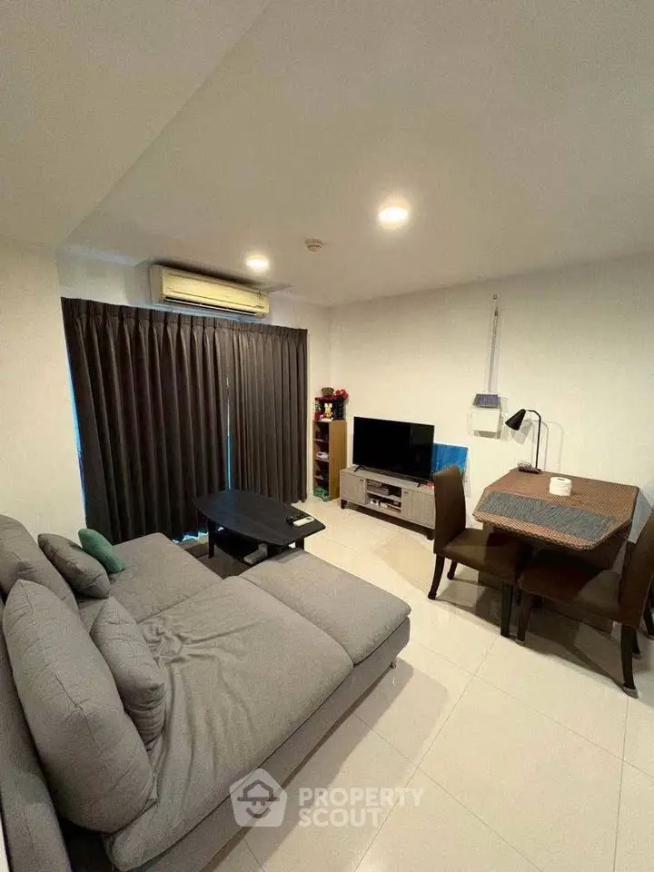 Cozy living room with modern furniture and dining area, perfect for relaxation and entertainment.