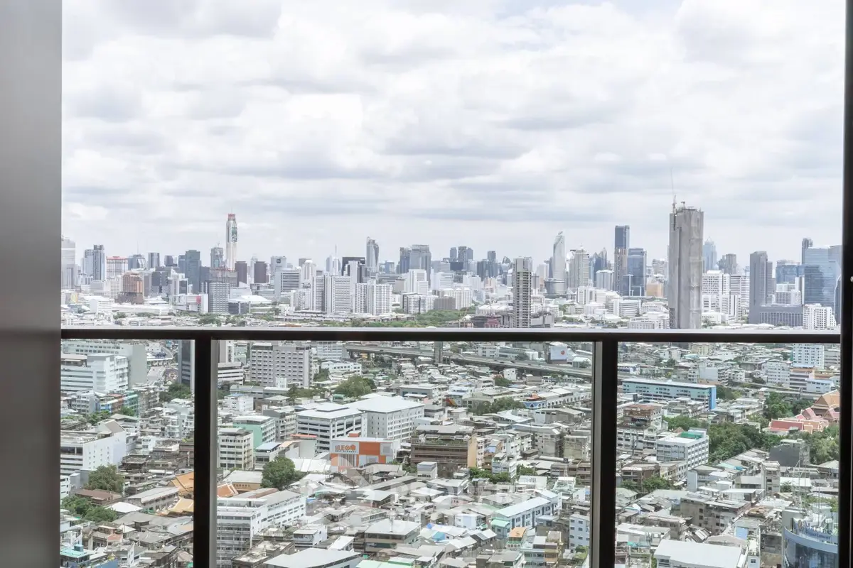 Stunning cityscape view from a high-rise balcony, showcasing urban skyline and vibrant city life.