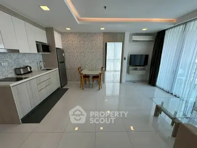 Modern open-layout kitchen and living area with sleek design and natural light