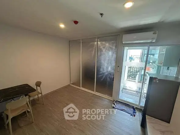 Modern apartment interior with balcony access and sleek furnishings