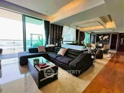 Luxurious living room with modern decor and expansive balcony view.