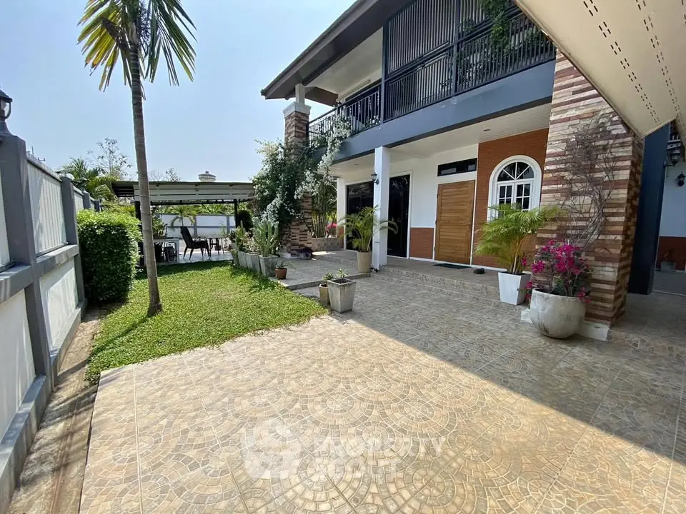 Stunning modern home exterior with lush garden and spacious patio, perfect for outdoor living.